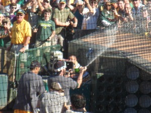 Players spraying the fans behind the visitor dugout